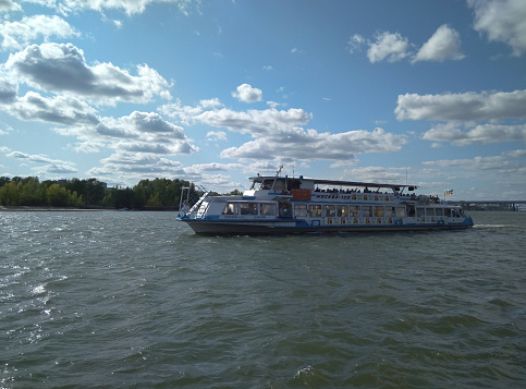 Russia, Novosibirsk 25.08.2019: white steamboat pleasure boat sails on the river with passengers