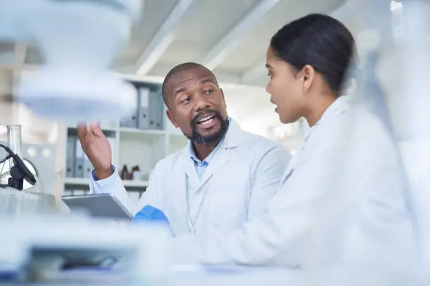 Shot of two scientists having a discussion in a lab