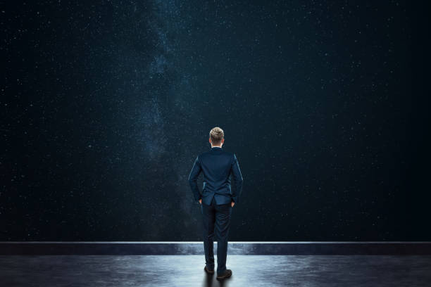 rear view businessman stands against the background of the starry sky. mixed media. concept dream, success, opportunity, development. - milky way galaxy space star imagens e fotografias de stock