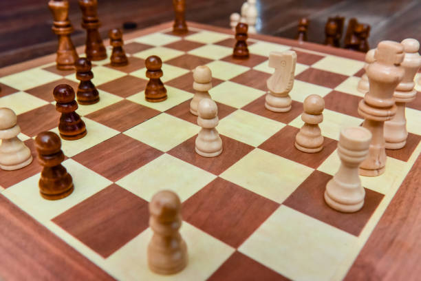 istock White and black chess pieces stand on board during a chess game 1302551235