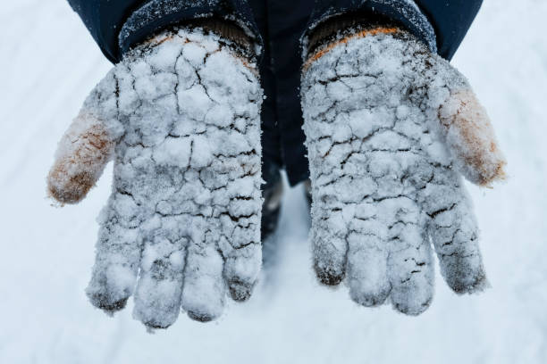 istock Close up on hand in snowed gloves 1302551426