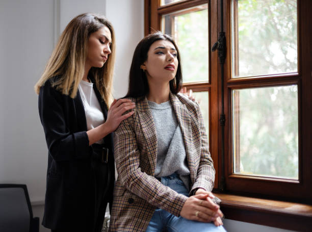 Businesswoman Supporting And Comforting Her Colleague Who Is Unhappy And Anxious Businesswoman Supporting And Comforting Her Colleague Who Is Unhappy And Anxious woman defeat stock pictures, royalty-free photos & images