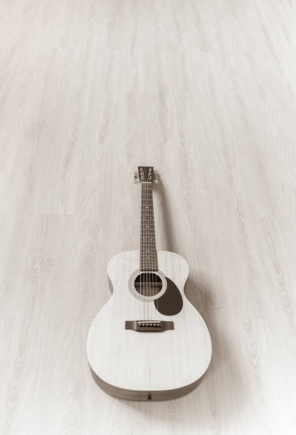 istock acoustic guitar on wooden floor 1302553985