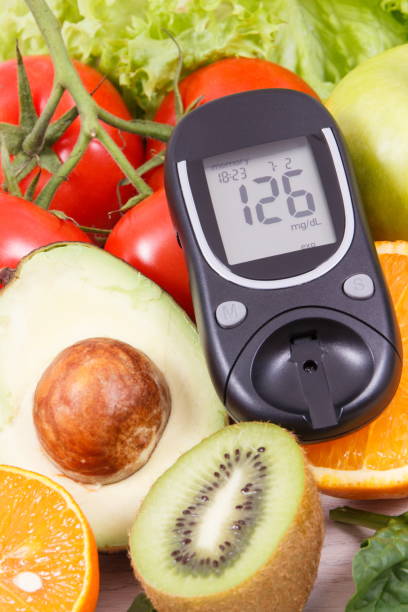 istock Glucometer for measuring sugar level and ripe fruits with vegetables as healthy nutritious snack containing vitamins 1302556541