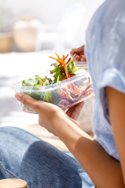 istock Woman Eating Salad 1302556712