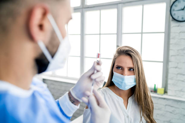 istock Woman having Vaccine Injection 1302558566