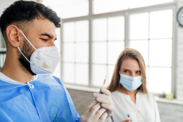 istock Woman having Vaccine Injection 1302558576