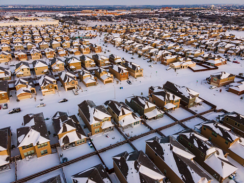 Sunrise over Texas Landscape covered in White Powder Snow during winter storm Uri over a foot of fresh snow in Round Rock north of Austin , Texas , USA