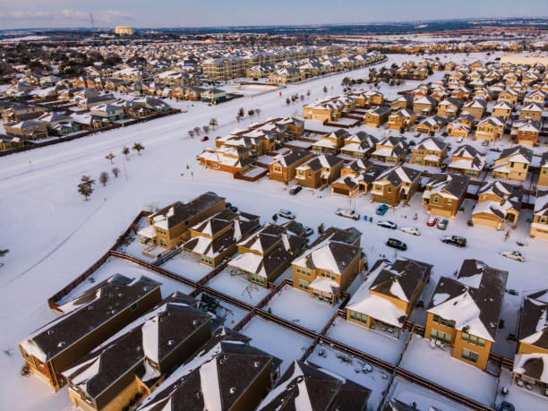 istock Suburb covered in winter snow thousands of rooftops with snow and ice 1302560297