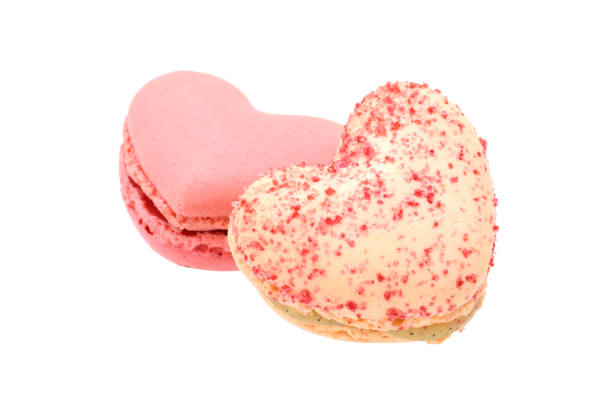 istock Pair of pink and white macaroons in heart shape isolated on white 1302561114