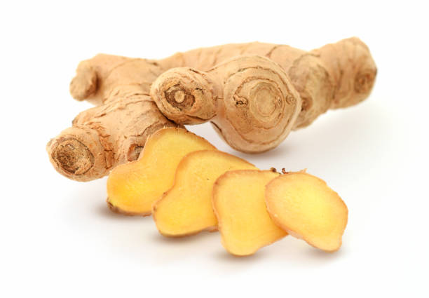 istock Ginger root fresh, raw cutted into slices isolated on white 1302561120