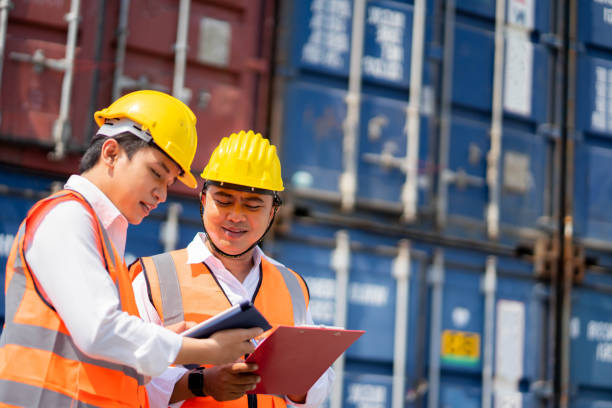 istock Engineer staff team checking and inspect container for international business logistic import and export concept. transportation import, export logistic industrial service. 1302561383