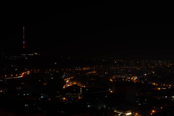 istock Light paths on the highway in the night city 1302565195