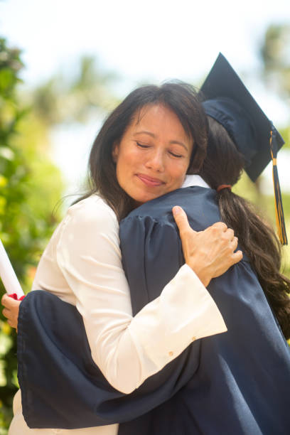 istock Mother hugging her daughter at her graduation 1302565858