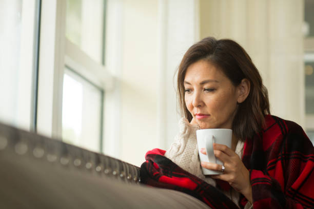 istock Mature woman feeling sad looking out a window. 1302566071