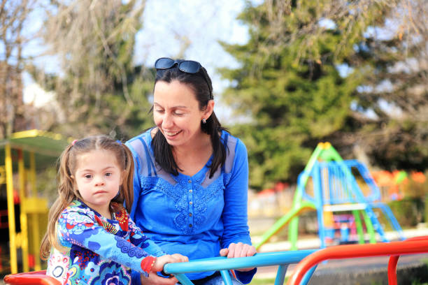 istock Mother and her daughter having fun in a playground 1302566950