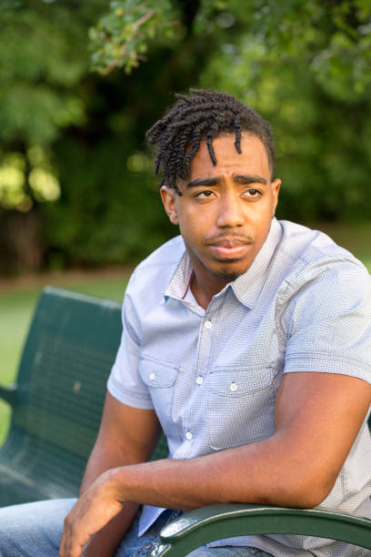 istock Young African American man in deep thought. 1302566990