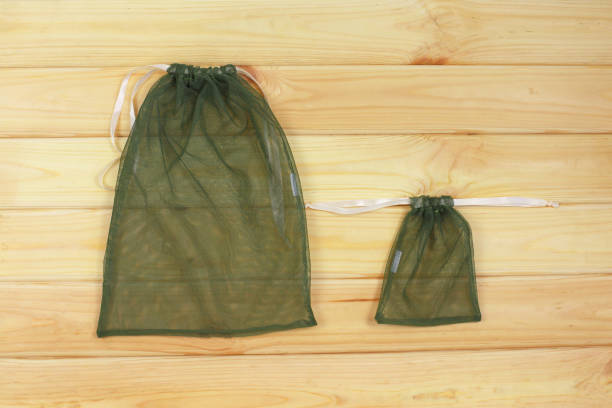 istock Reusable eco friendly mesh bags on wood background. 1302567943