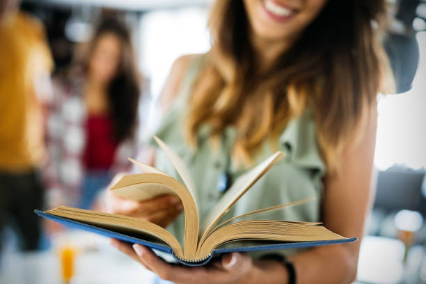 istock People, knowledge, education and school concept. Happy student girl with book 1302570364