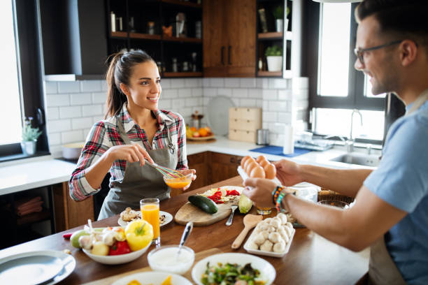 istock Beautiful young couple having fun in the kitchen while cooking. 1302570530