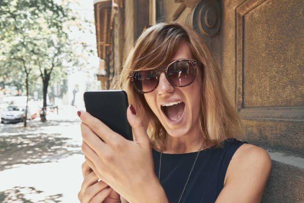 istock Woman using modern smartphone on the street. 1302570751