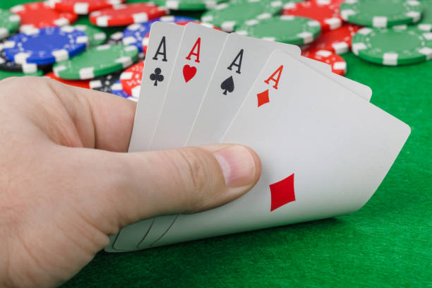 istock Hand with playing cards in casino 1302571962