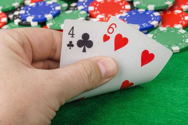 istock Hand with playing cards in casino 1302571979