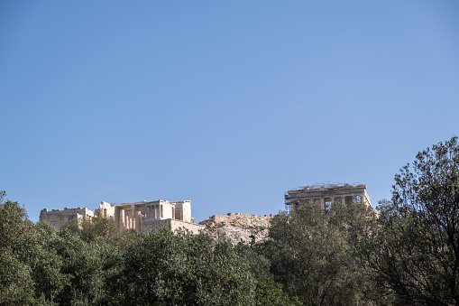 Acropolis of Athens Greece rock and Parthenon on blue sky background, sunny day. View from Dionisiou areopagitou street