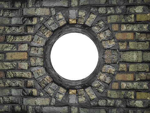 Frame in the shape of a circle window lined with old, aged damaged yellow bricks isolated on a white background.