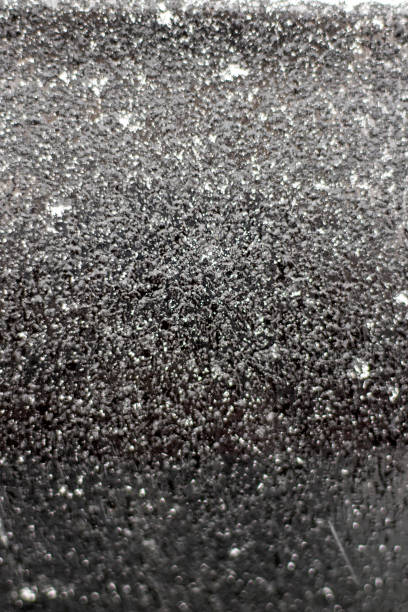 istock abstract background, frost on the black surface of the machine, vertical 1302572838