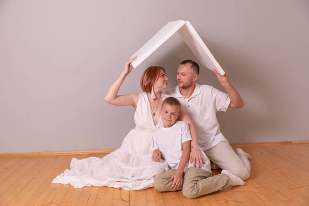 istock Happy young family under a safe roof, concept 1302573349
