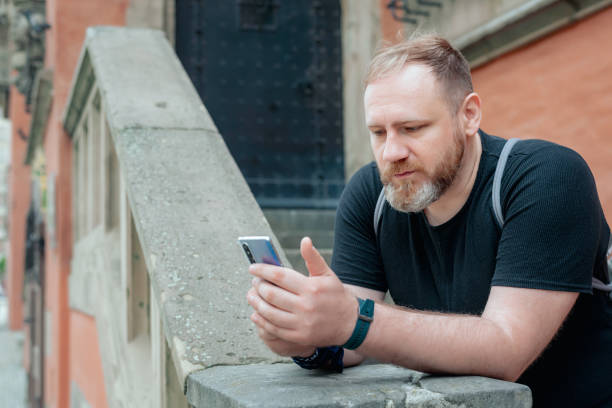 istock adult man texting by smartphone 1302575885