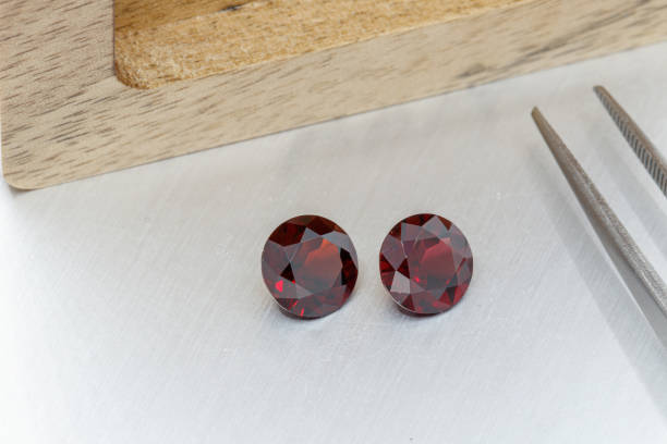 istock macro mineral faceted stone cut Garnet on a gray background 1302576421