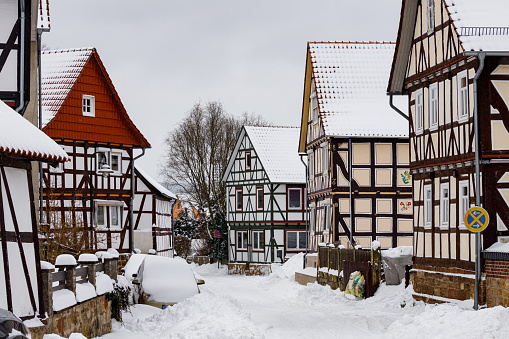 Herleshausen, Hesse, Germany - February 08, 2021: Half timbered houses of Herleshausen in Germany with snow in the winter