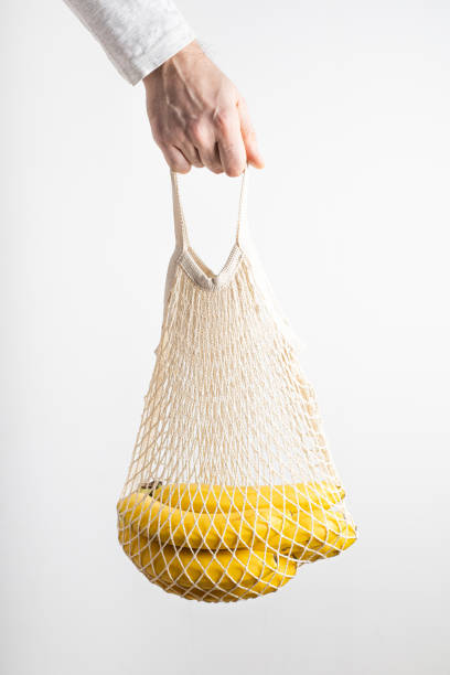 istock A man's hand holds an eco-friendly bag with ripe bananas 1302578913
