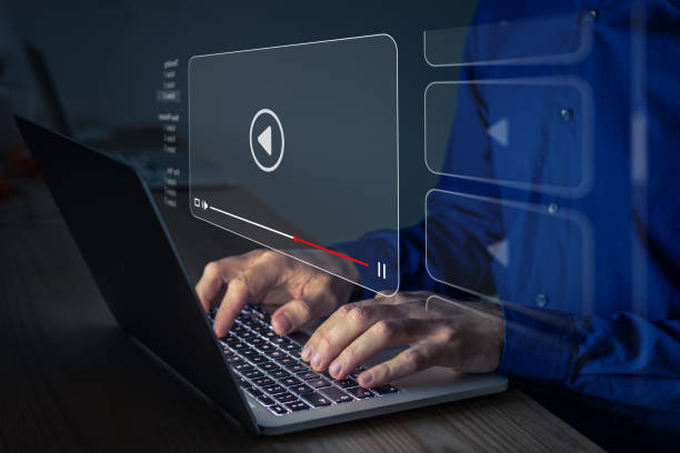 Video streaming on internet. Person watching online movie or TV series on laptop computer screen. Concept about subscription based live digital stream or channels, multimedia player with play button Video streaming on internet. Person watching online movie or TV series on laptop computer screen. Concept about subscription based live digital stream or channels, multimedia player with play button image based social media photos stock pictures, royalty-free photos & images