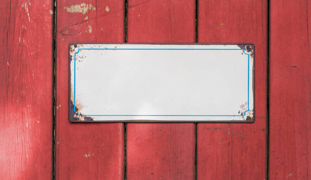 istock Empty tin sign in front of a wooden wall 1302580384