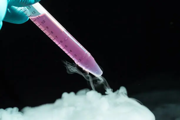 Laboratory test tube with fluid biological sample which is extracted from liquid nitrogen, scientific research concept