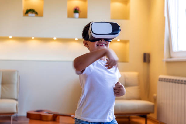istock Cheerful Little Boy is Having Fun with VR Glasses. The Future has Arrived. 1302582040