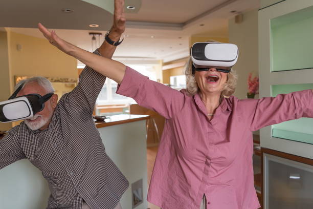 istock Mature Couple Playing Virtual Reality Games 1302582454