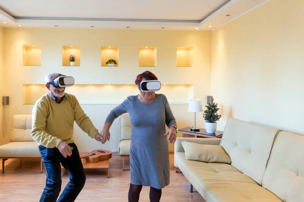 istock Cheerful Older Man and his Wife are Experiencing Video Games on Virtual Reality Simulator. 1302583121