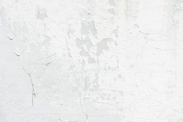 istock A concrete white wall with a cracked and peeling surface 1302589548