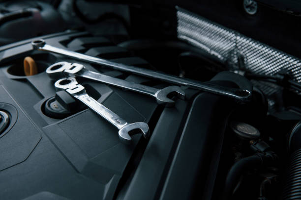 istock Three wrenches. Repair tools lying down on the engine of automobile under the hood 1302589549