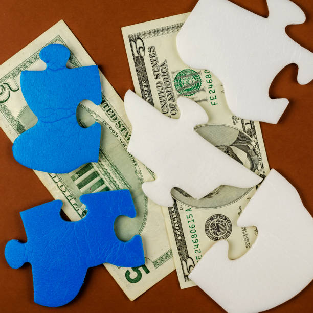 istock American five-dollar bills are hidden under the puzzle pieces. 1302592067