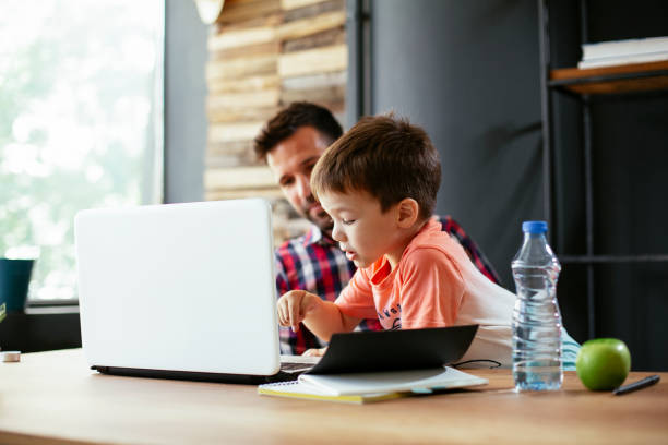 istock Young businessman with his son in the office 1302593140