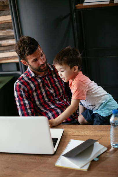 istock Young businessman with his son in the office 1302593142