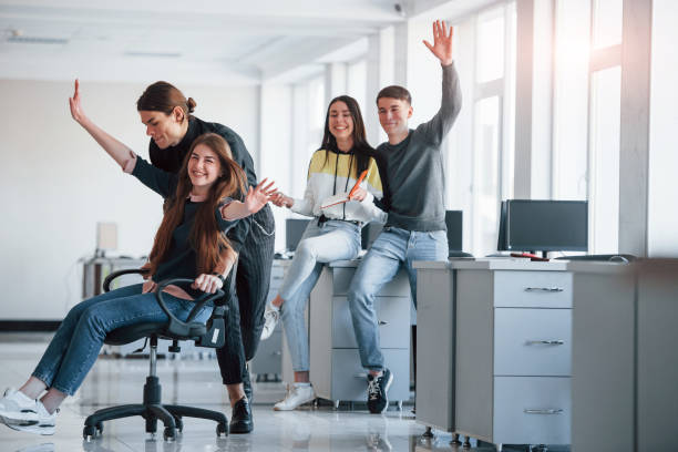 istock Speed and smiles. Having fun in the office. Young people have a break and driving by using a seat 1302594543