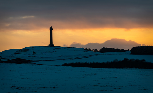 Wellington Monument in the Scottish Borders in winter snow at dusk