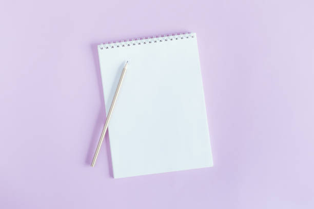 istock Notebook with blank page and pencil on a violet pastel background. 1302598102