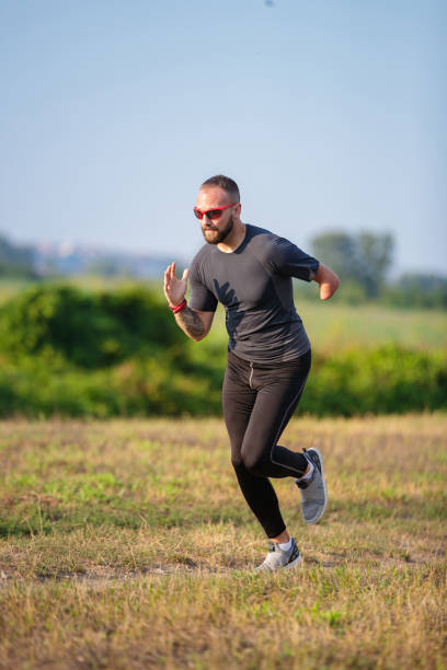 istock Differently abled young man warming up for running in nature 1302598253